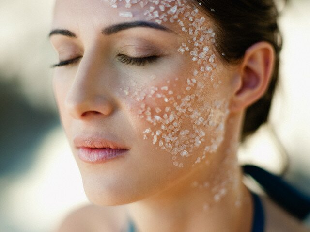 Young woman with sea salt on her face
